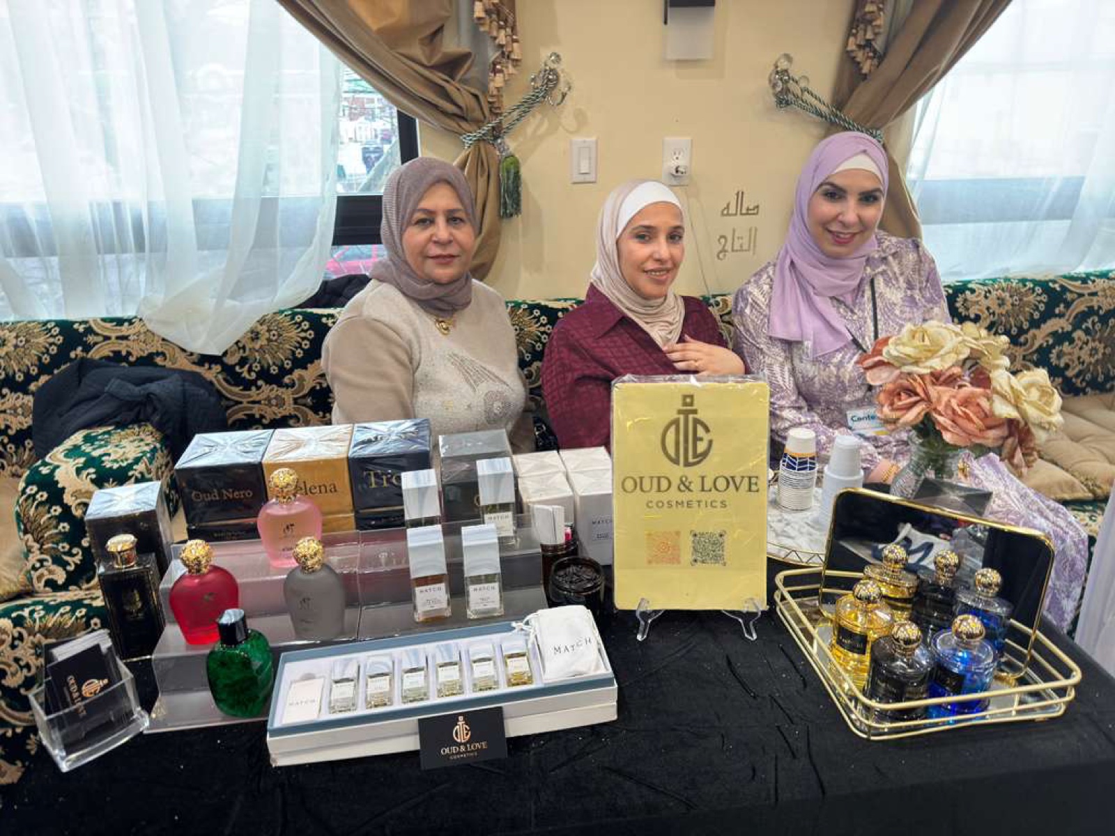Women entrepreneurs at the Oud and Love Cosmetics table during an ARWA community bazaar
