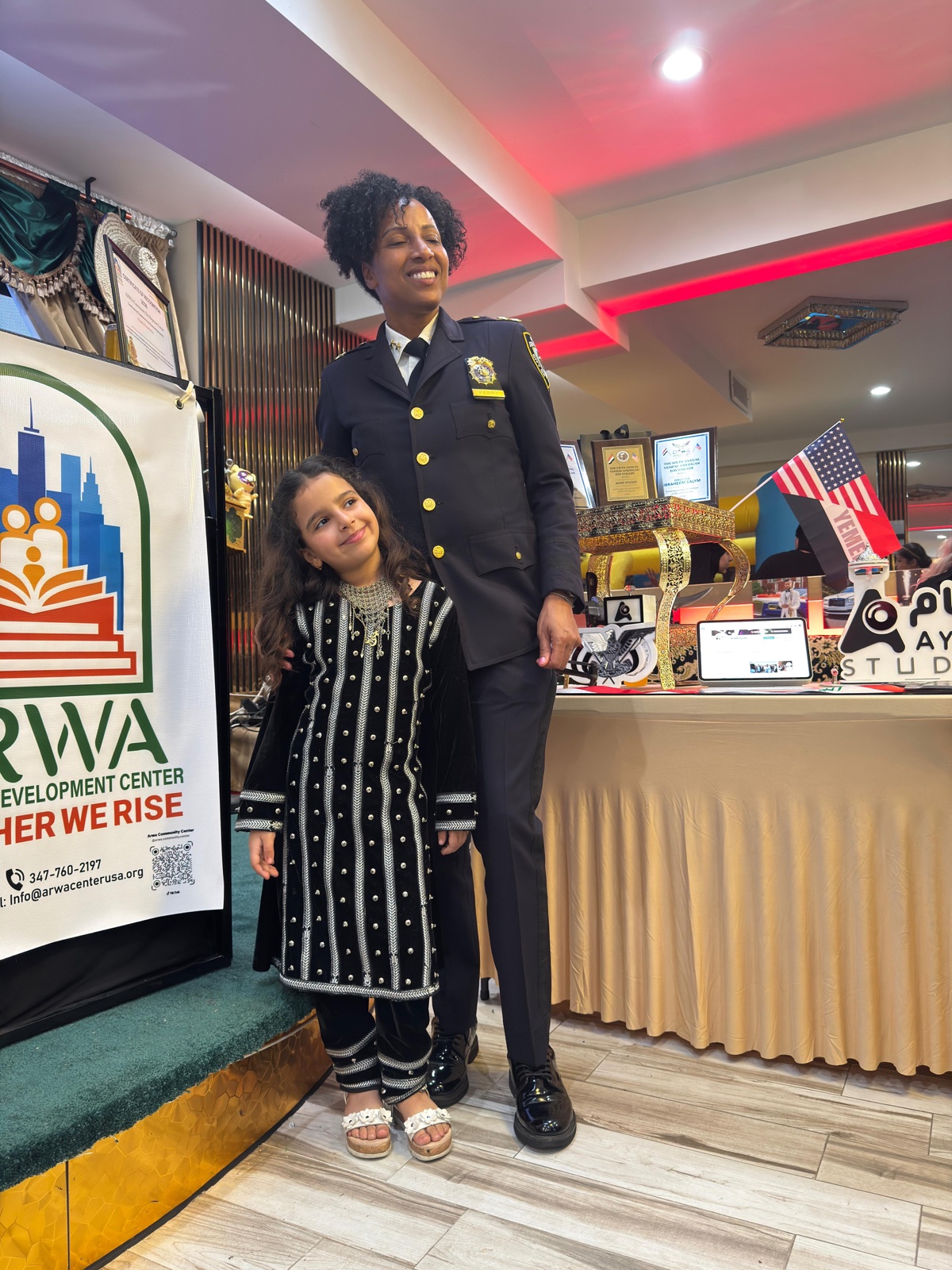 NYPD officer with a young community member at an ARWA community recognition event